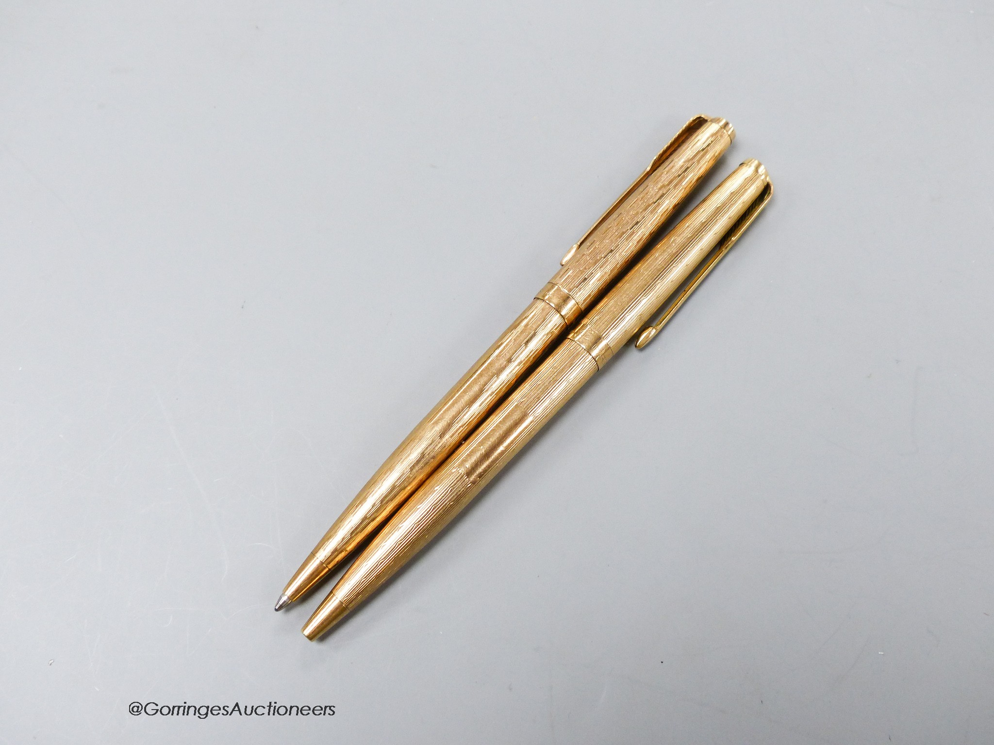 Two 9ct gold cased Parker pens.